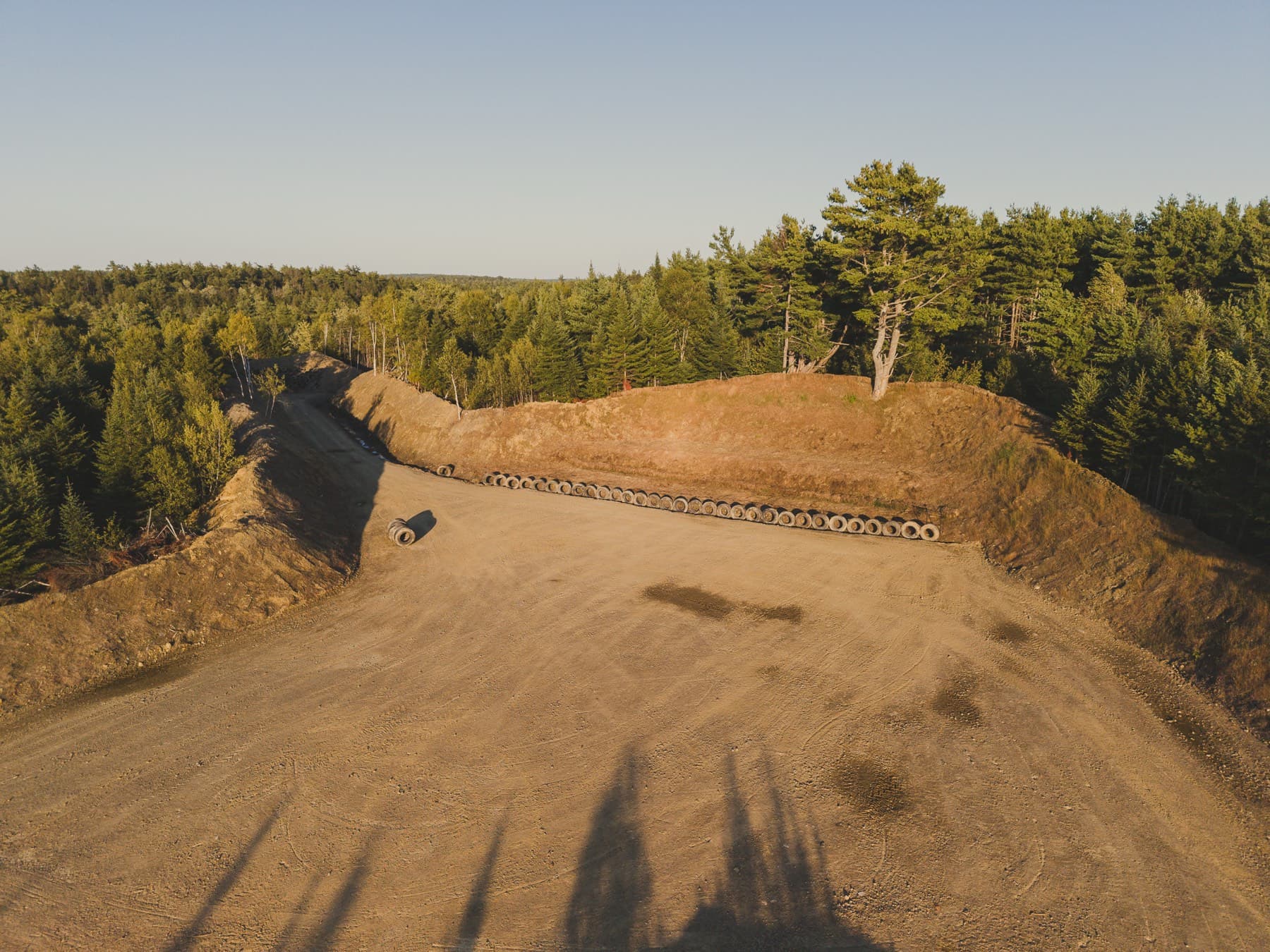 The range backstop at NSSR: a graded earthen berm faced with a row of embedded tires behind the firing line.