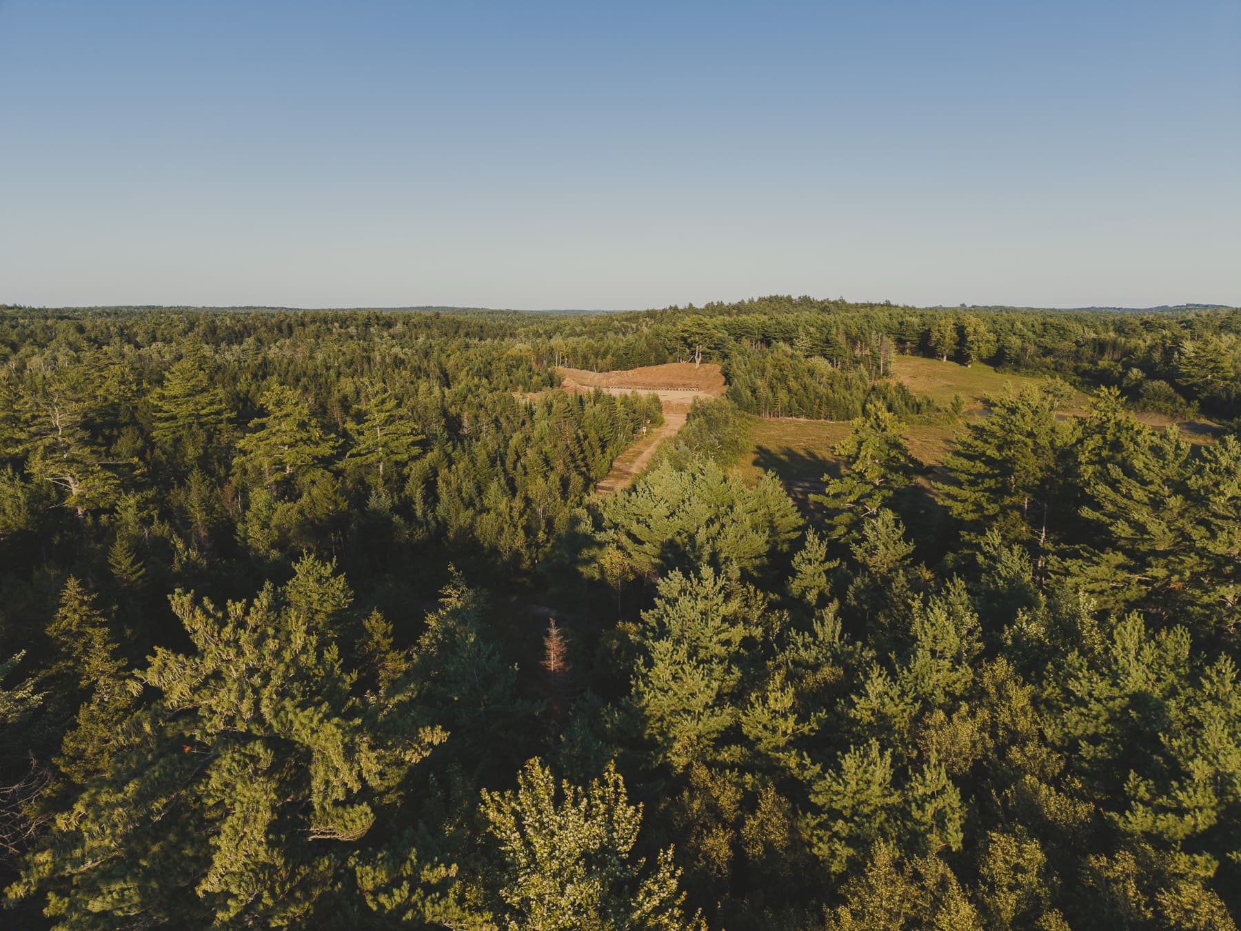 Aerial view showing the depth of woodland surrounding the NSSR range, the natural buffer between the range and its neighbours.